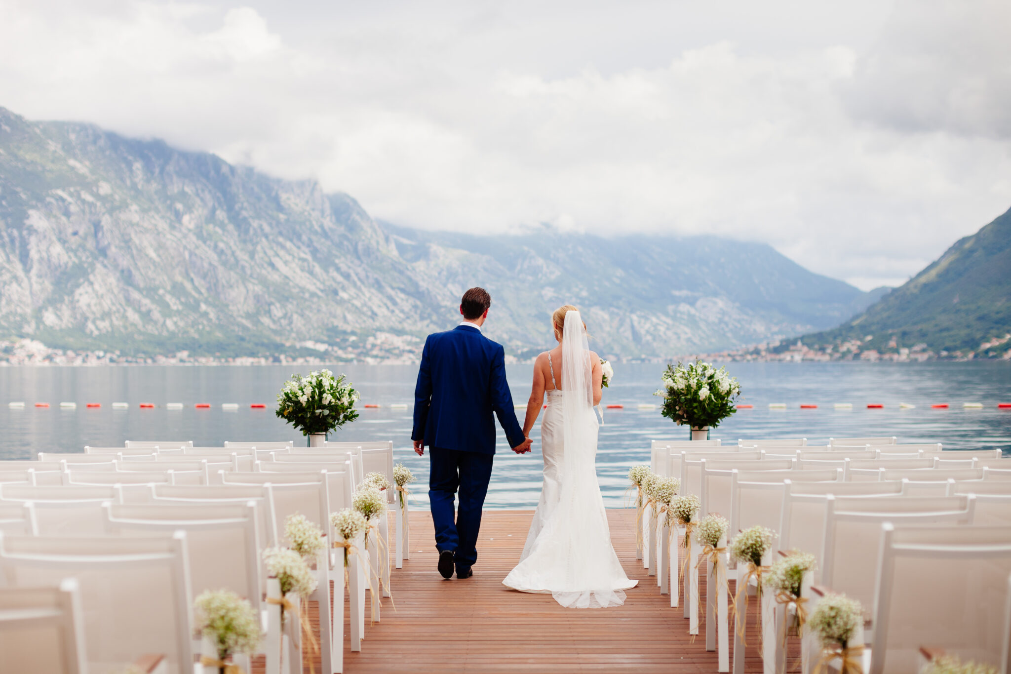 wedding couple at destination wedding ceremony. Mountains and sea view in Montenegro. Picturesque wedding location.